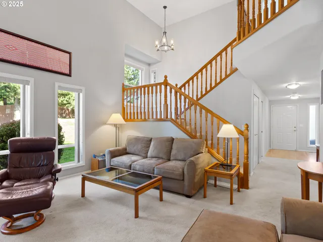 a living room with furniture rug and a window