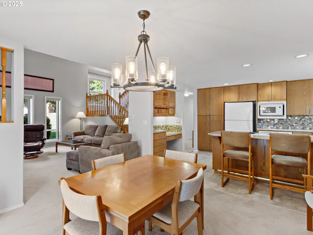 a living room with furniture a dining table and chairs