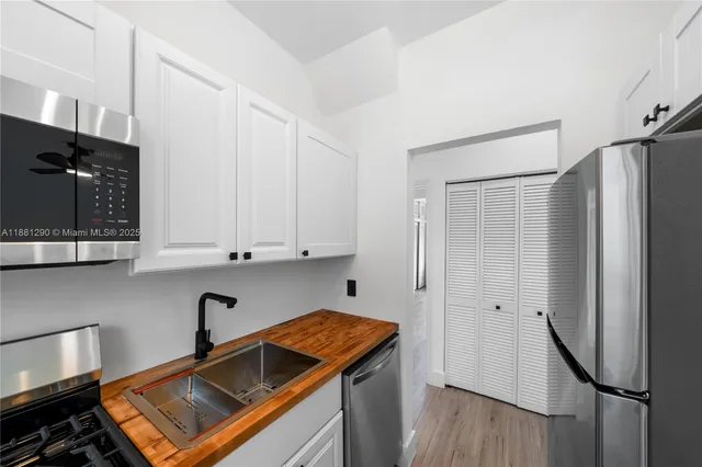a kitchen with stainless steel appliances granite countertop a refrigerator and a stove top oven