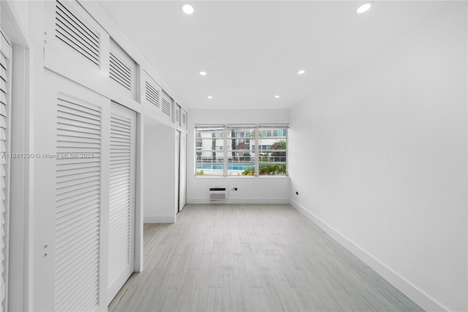 4710 Pine Tree Drive, Unit 31 Miami Beach, FL 33140 - Photo 21 of 25 a view of a big room with wooden floor and windows