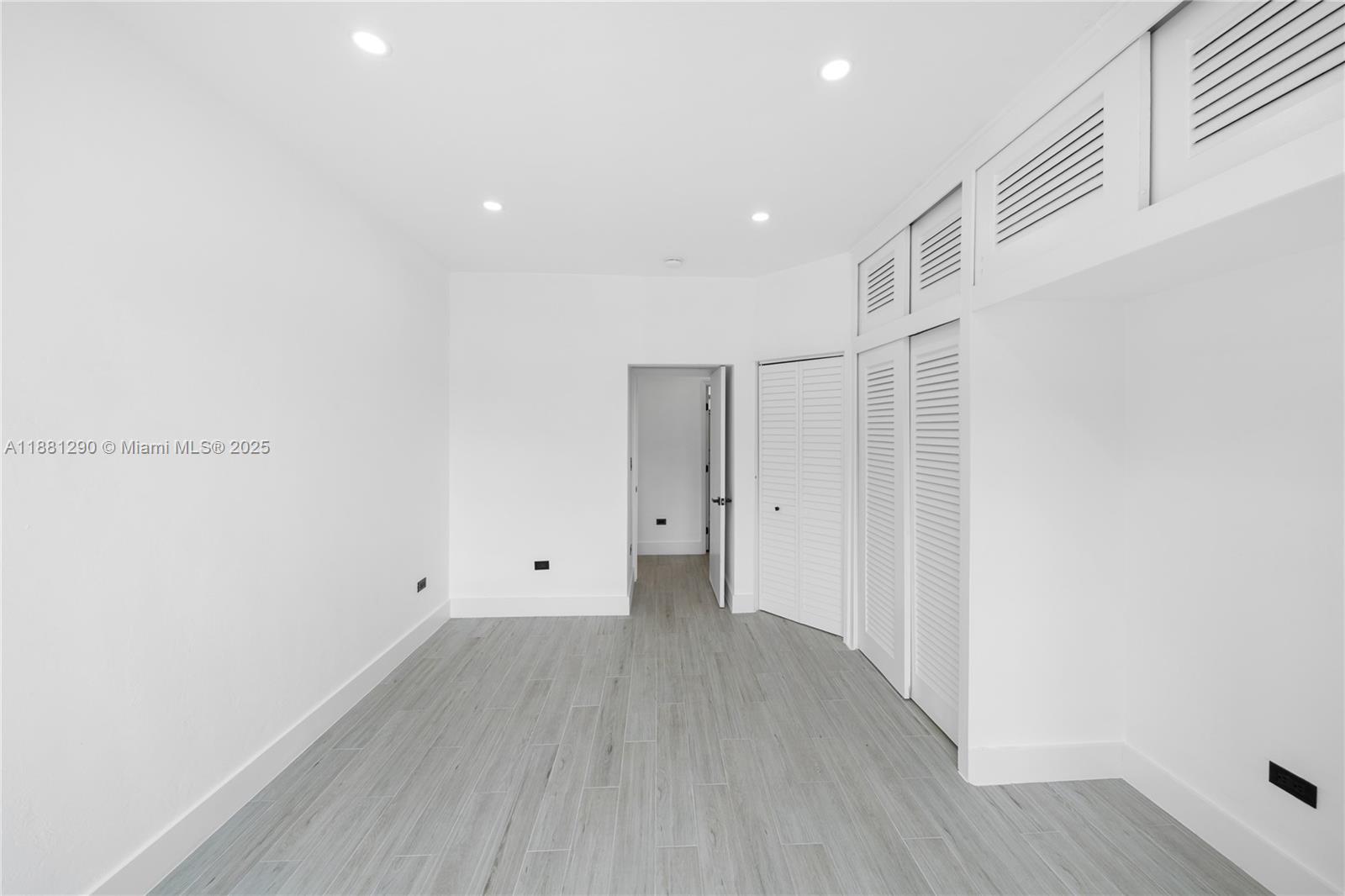 4710 Pine Tree Drive, Unit 31 Miami Beach, FL 33140 - Photo 24 of 25 a view of room with wooden floor and window