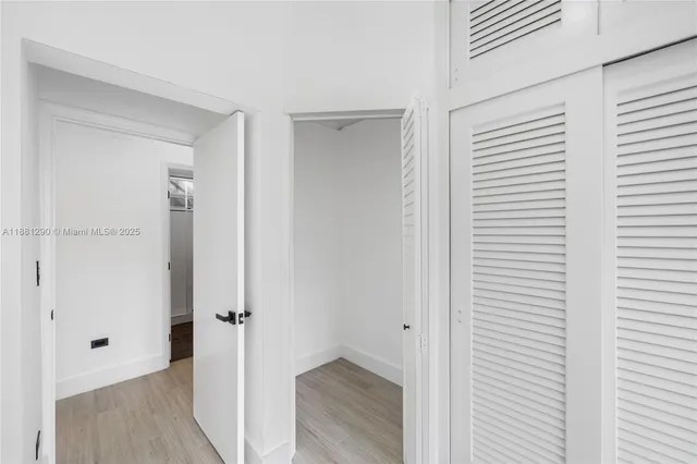 a view of a hallway with wooden floor