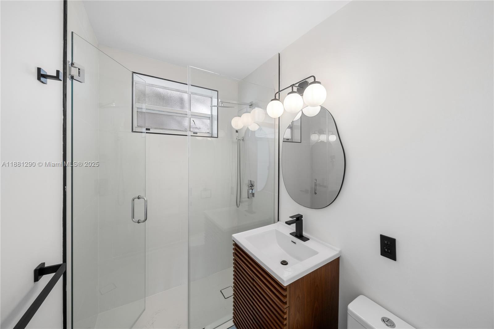 4710 Pine Tree Drive, Unit 31 Miami Beach, FL 33140 - Photo 6 of 25 a bathroom with a sink a mirror and a toilet