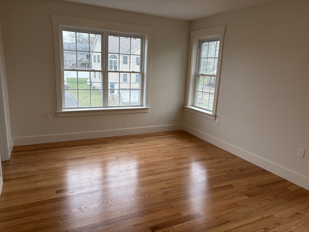 76 Valmor Street Worcester, MA 01604 - Photo 17 of 20 a view of an empty room with wooden floor and a window
