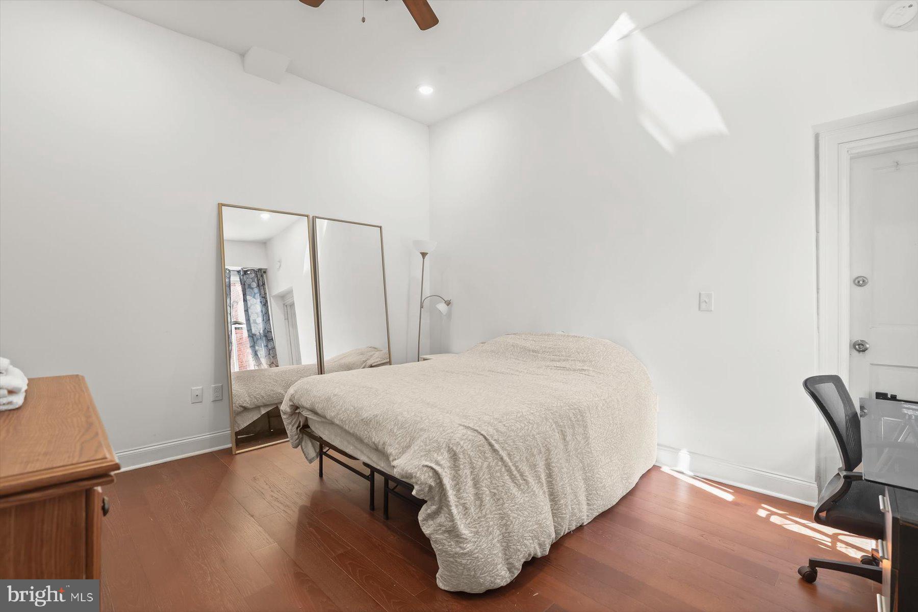 14 East Read Street Baltimore, MD 21202 - Photo 12 of 61 a bedroom with a bed and a chair