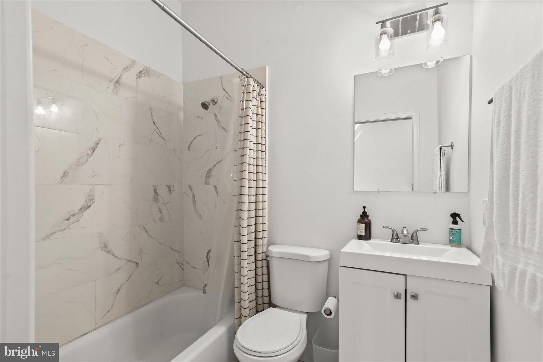 14 East Read Street Baltimore, MD 21202 - Photo 13 of 61 a bathroom with a sink toilet and shower