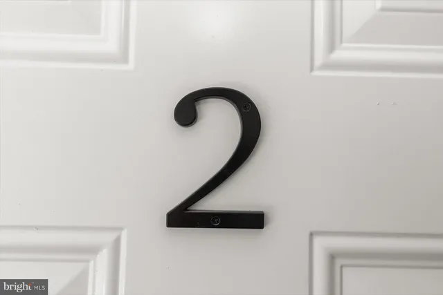 a bathroom with a granite countertop toilet and sink