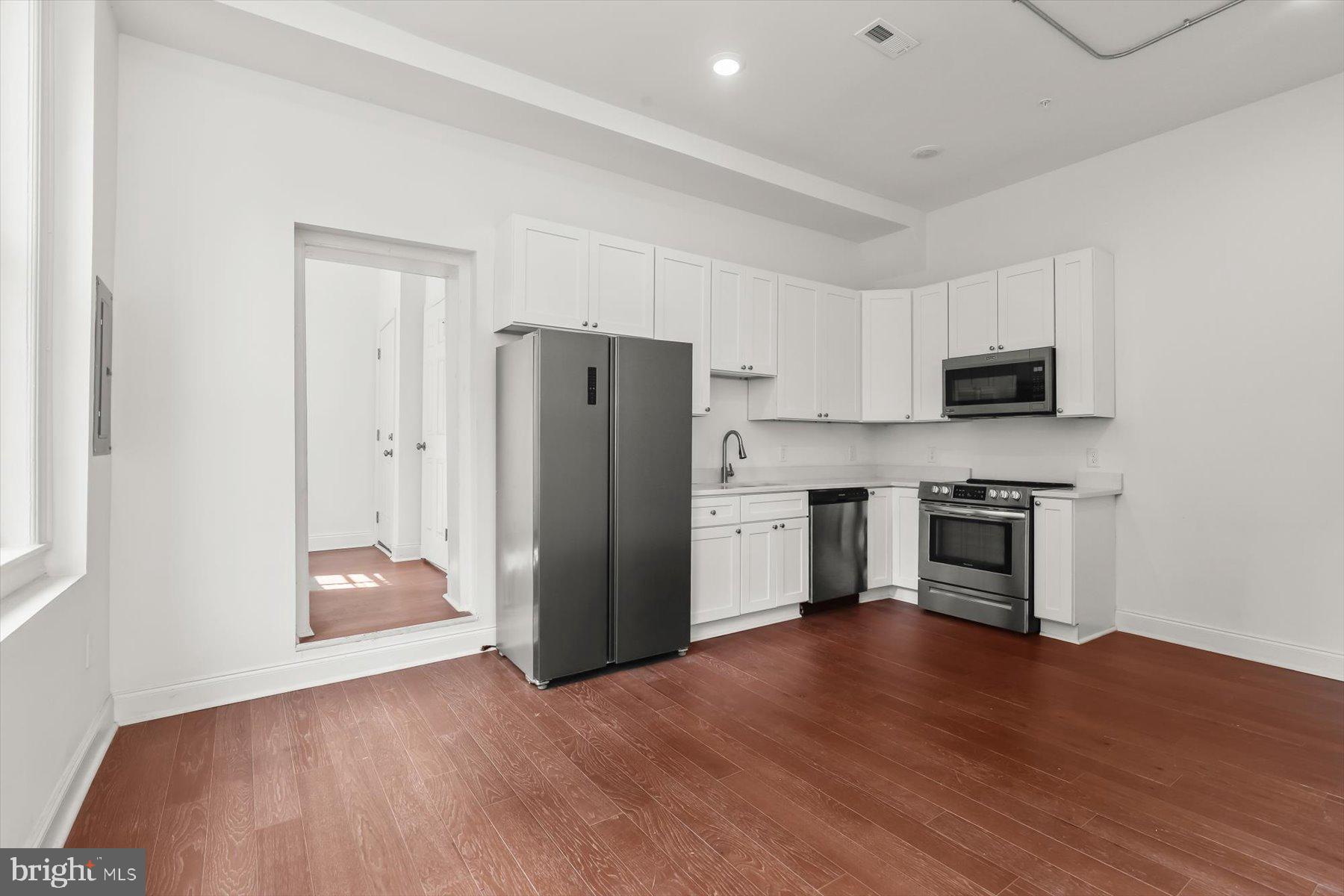14 East Read Street Baltimore, MD 21202 - Photo 17 of 61 a kitchen with a refrigerator and a stove top oven
