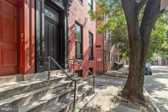 a view of a white house with a tree