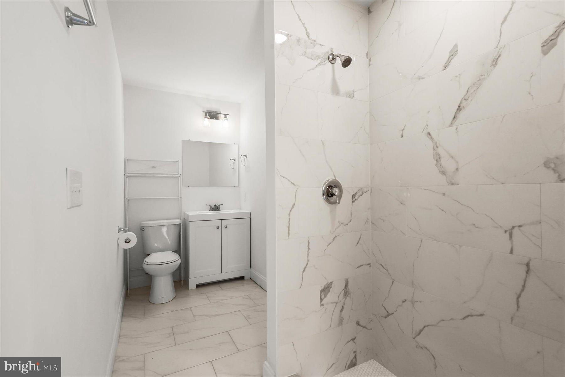 14 East Read Street Baltimore, MD 21202 - Photo 21 of 61 a bathroom with a granite countertop toilet and sink