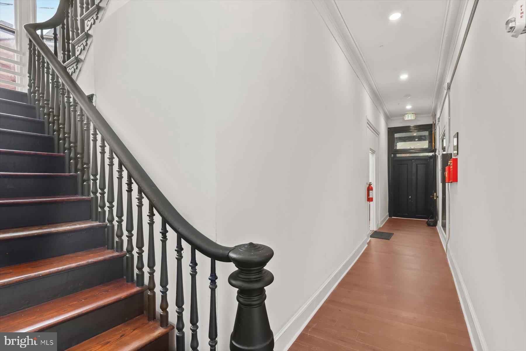 14 East Read Street Baltimore, MD 21202 - Photo 23 of 61 a view of a hallway with wooden floor and stairs