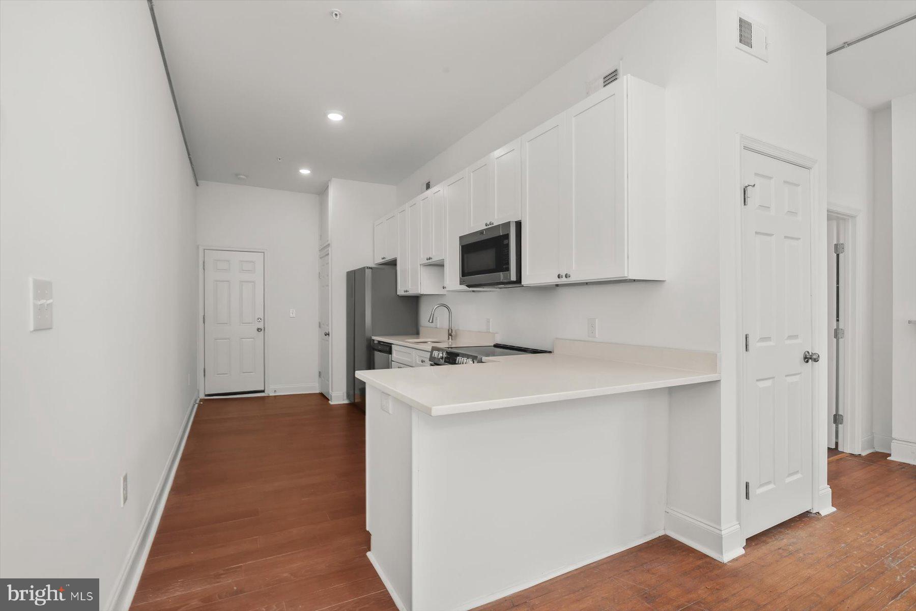 14 East Read Street Baltimore, MD 21202 - Photo 26 of 61 a kitchen with stainless steel appliances a sink stove and refrigerator