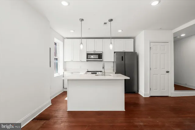 a view of a hallway with washer and dryer