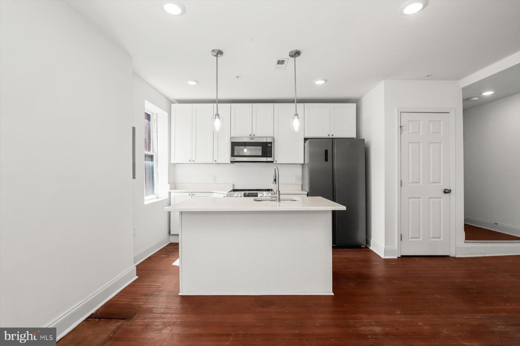 14 East Read Street Baltimore, MD 21202 - Photo 33 of 61 a kitchen with stainless steel appliances a sink stove and refrigerator