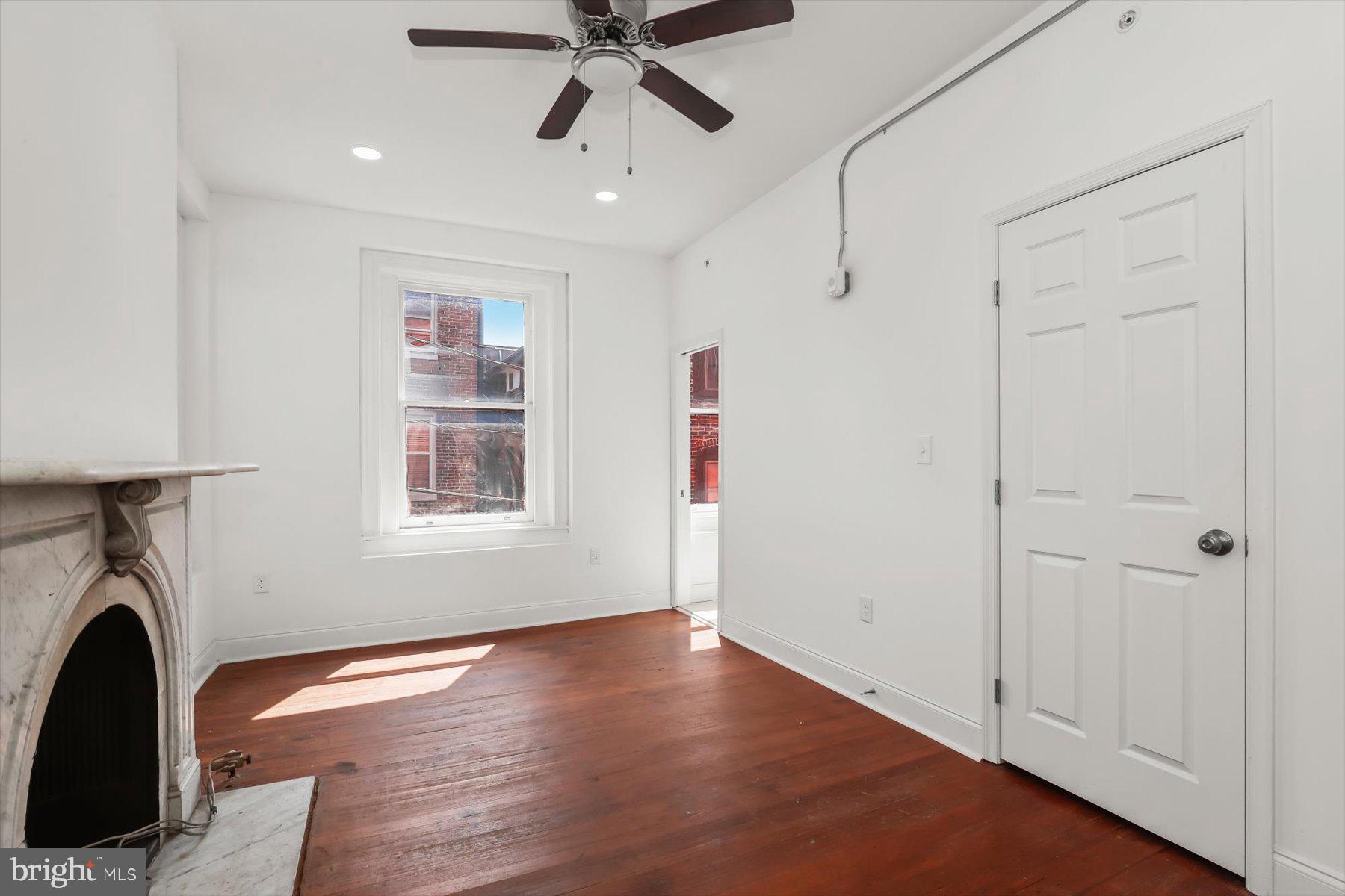 14 East Read Street Baltimore, MD 21202 - Photo 36 of 61 a view of empty room with wooden floor and fan