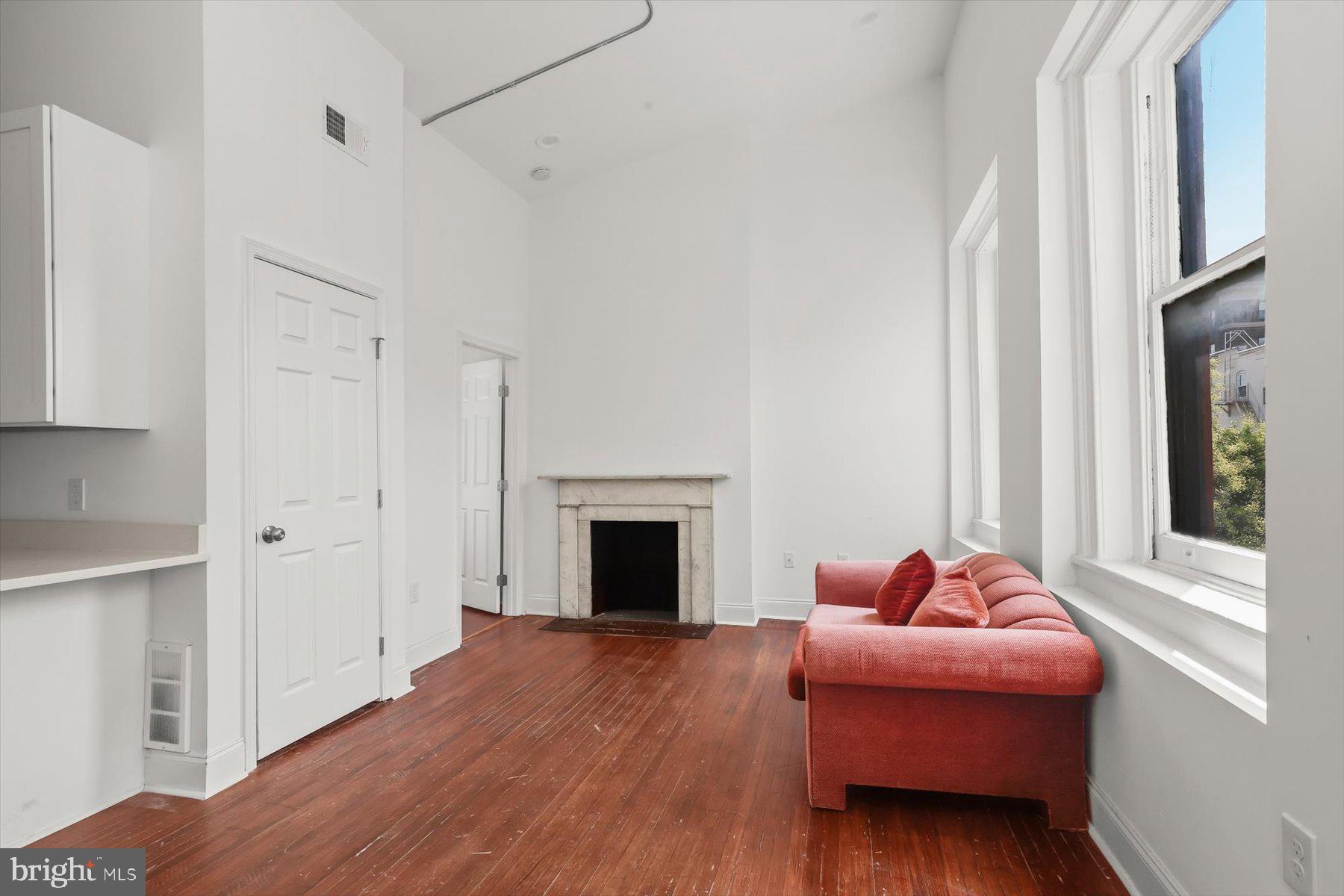 14 East Read Street Baltimore, MD 21202 - Photo 46 of 61 a living room with furniture a fireplace and a window