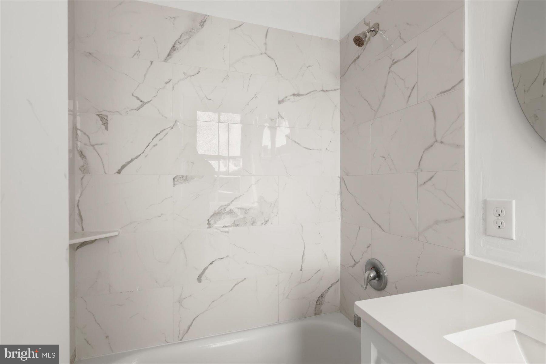 14 East Read Street Baltimore, MD 21202 - Photo 49 of 61 a bathroom with a bathtub and shower