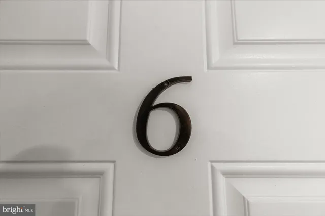 a white building that has a street sign on it