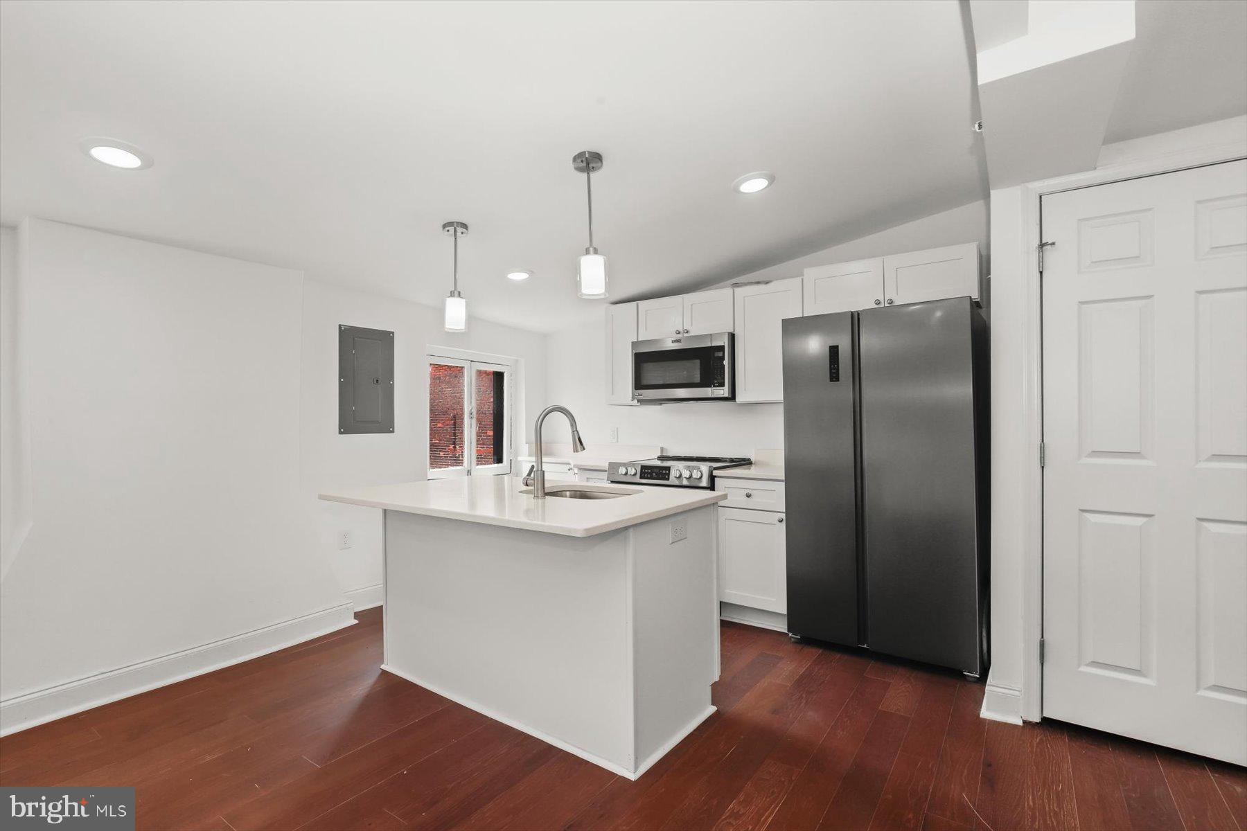 14 East Read Street Baltimore, MD 21202 - Photo 52 of 61 a kitchen with stainless steel appliances granite countertop a refrigerator and a sink