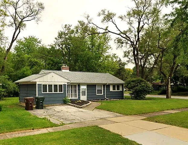 a front view of a house with yard porch and green space