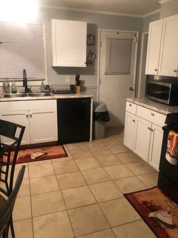 a kitchen with a sink a stove and a microwave