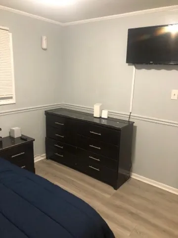 a room with a dresser and a television