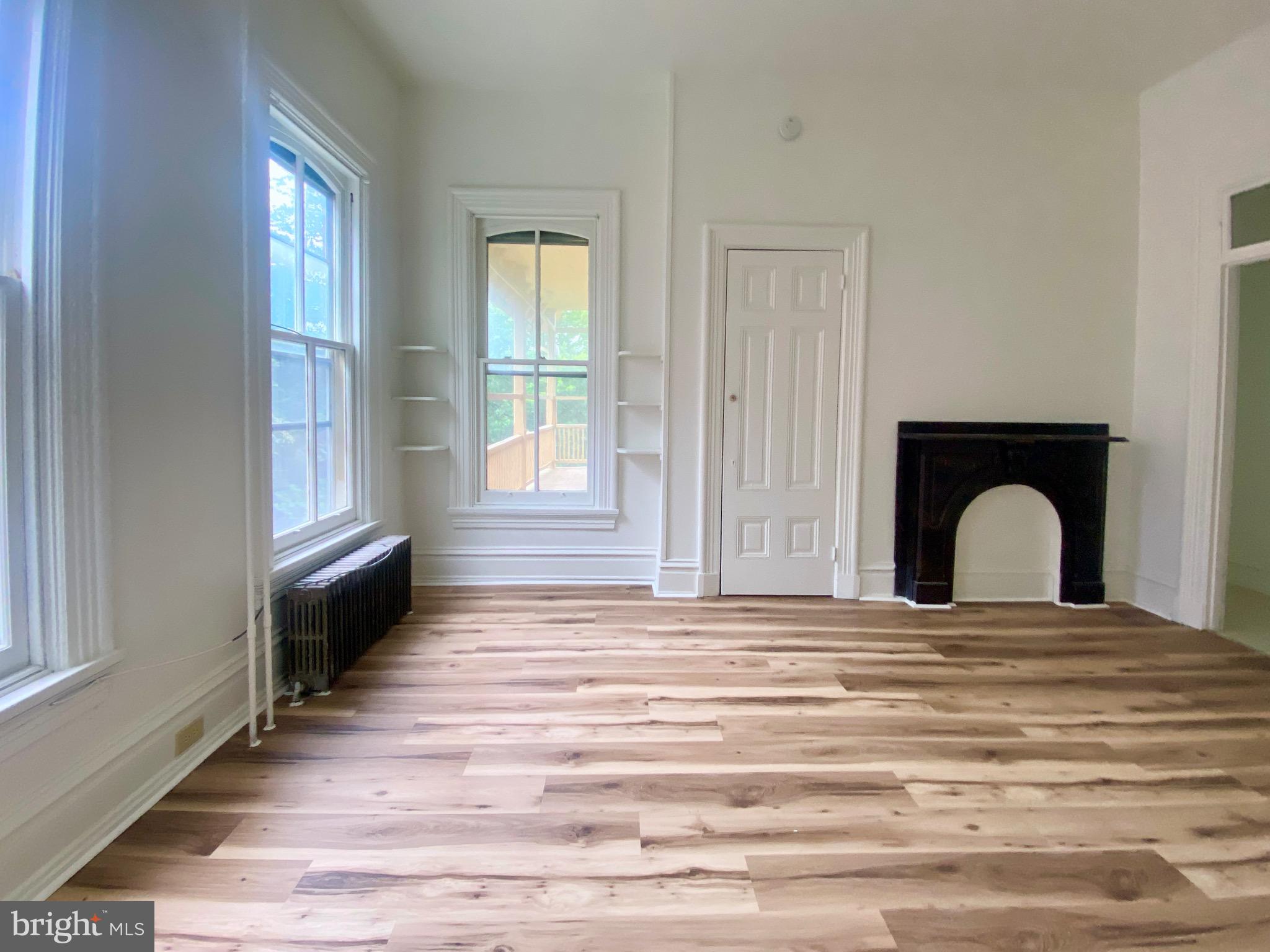 26 South 2nd Street, Unit 2 Columbia, PA 17512 - Photo 8 of 14 a view of a livingroom with wooden floor and a fireplace