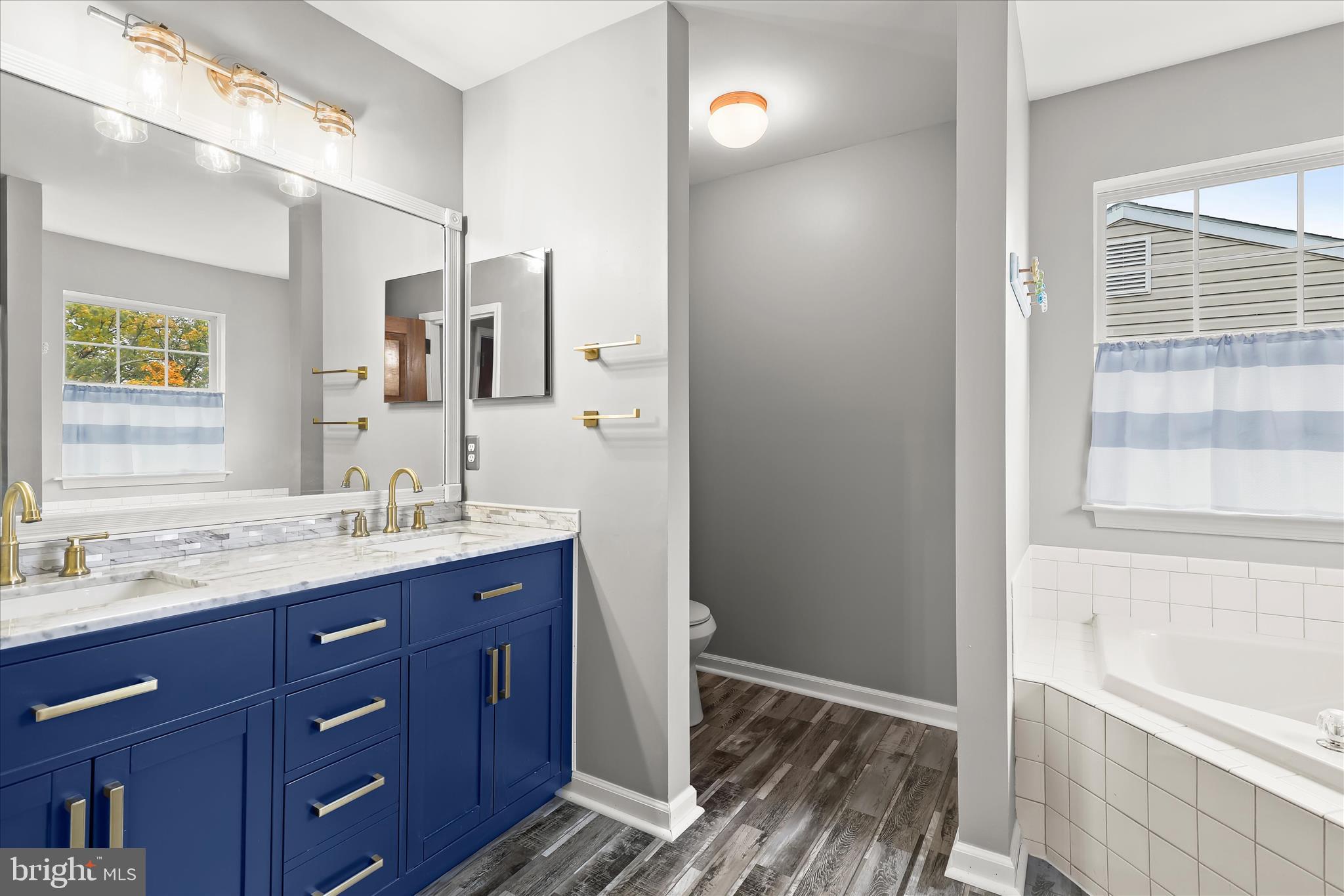 147 Idlewild Road Severna Park, MD 21146 - Photo 18 of 36 a bathroom with a granite countertop sink toilet and shower