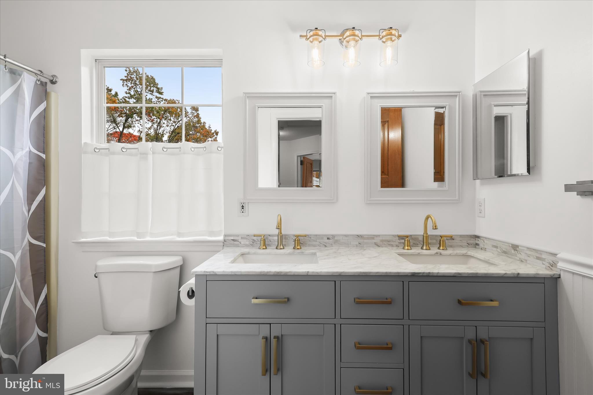 147 Idlewild Road Severna Park, MD 21146 - Photo 25 of 36 a bathroom with a granite countertop toilet sink and mirror