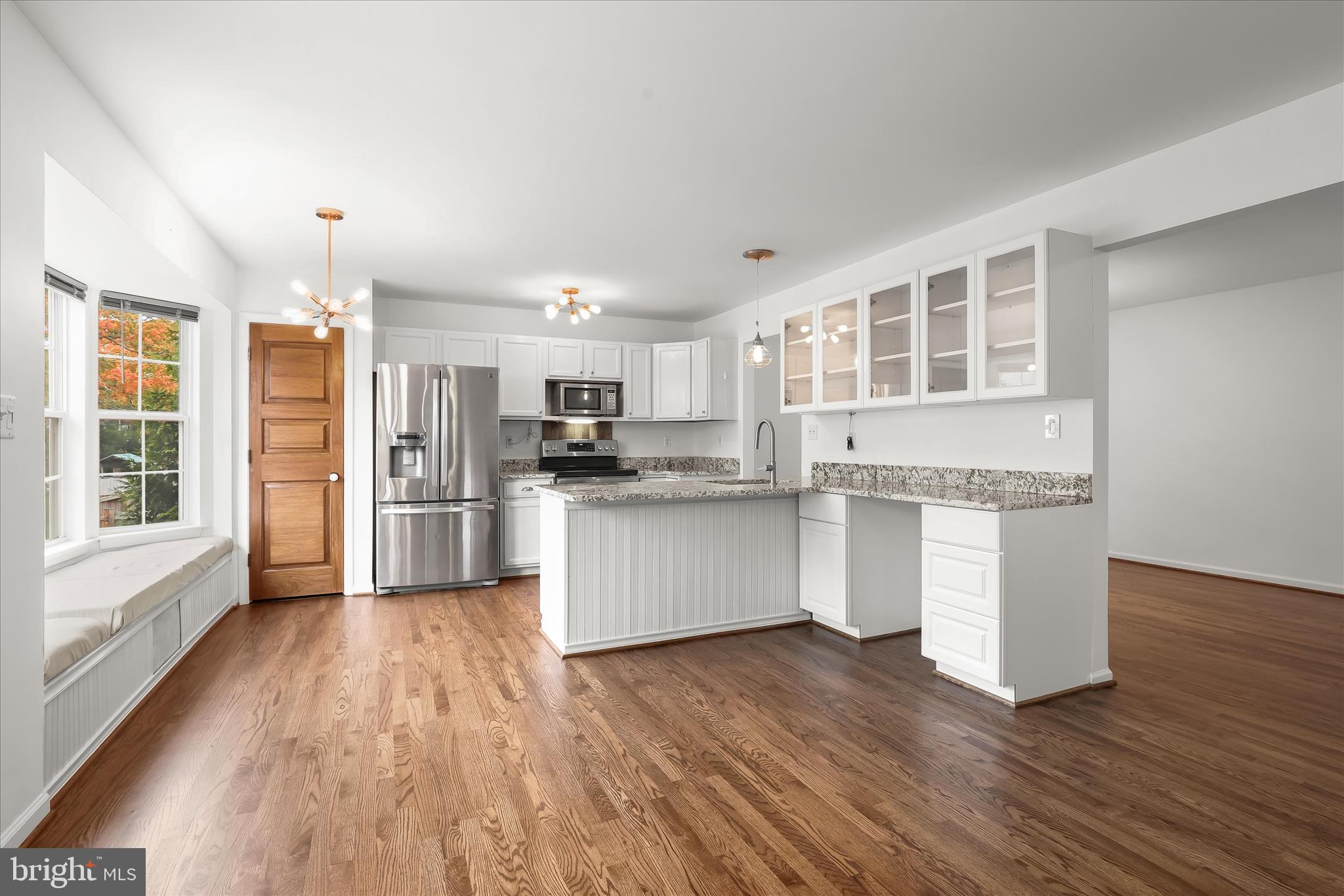 147 Idlewild Road Severna Park, MD 21146 - Photo 6 of 36 a kitchen with white cabinets and wooden floor
