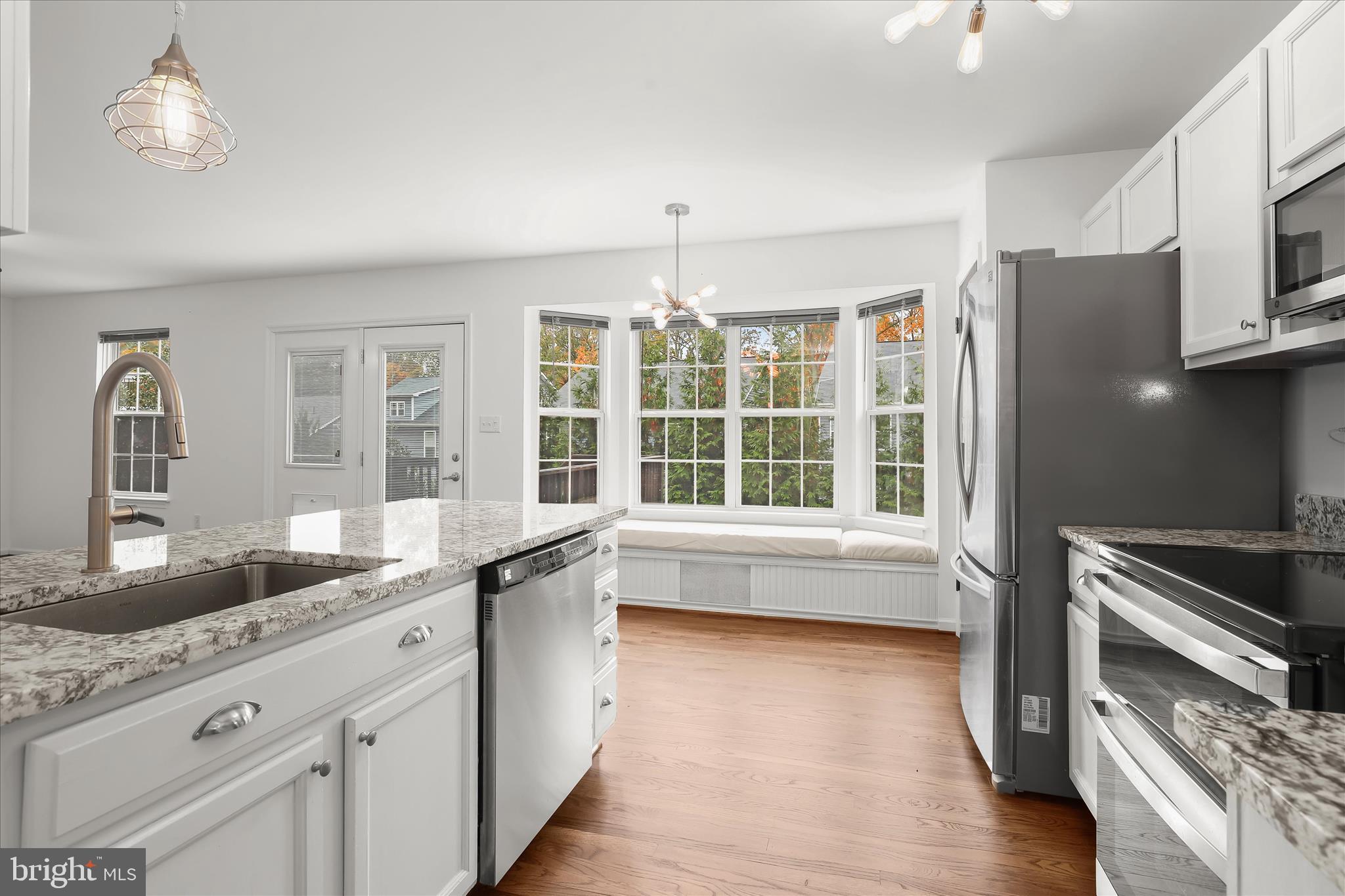 147 Idlewild Road Severna Park, MD 21146 - Photo 8 of 36 a kitchen with granite countertop a stove a sink and a refrigerator