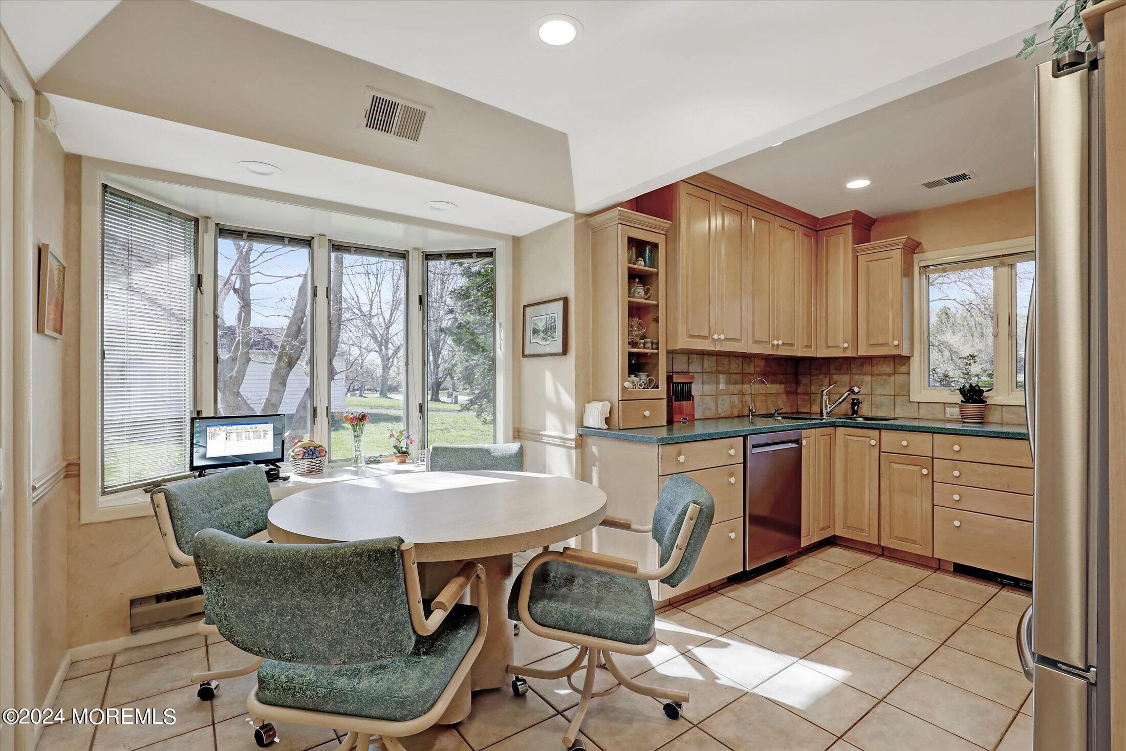 31 Shady Lane Freehold, NJ 07728 - Photo 11 of 40 a kitchen with granite countertop kitchen island dining table and chairs