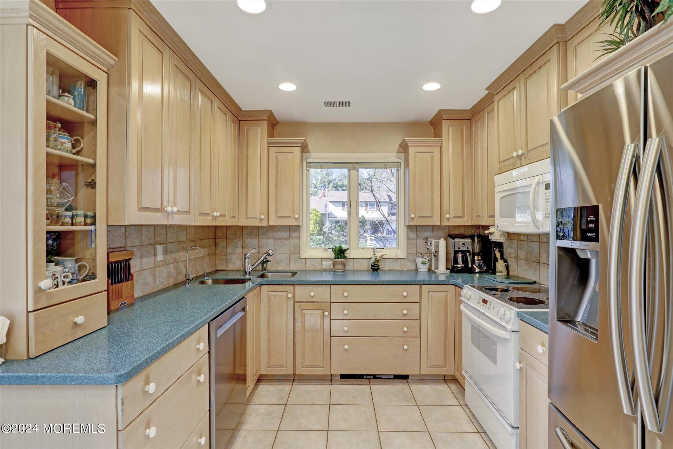 31 Shady Lane Freehold, NJ 07728 - Photo 12 of 40 a kitchen with a sink stove and cabinets