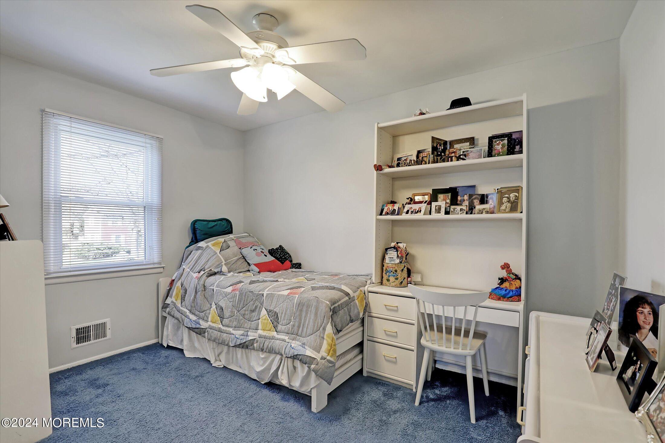31 Shady Lane Freehold, NJ 07728 - Photo 22 of 40 a bedroom with a bed and a book shelf