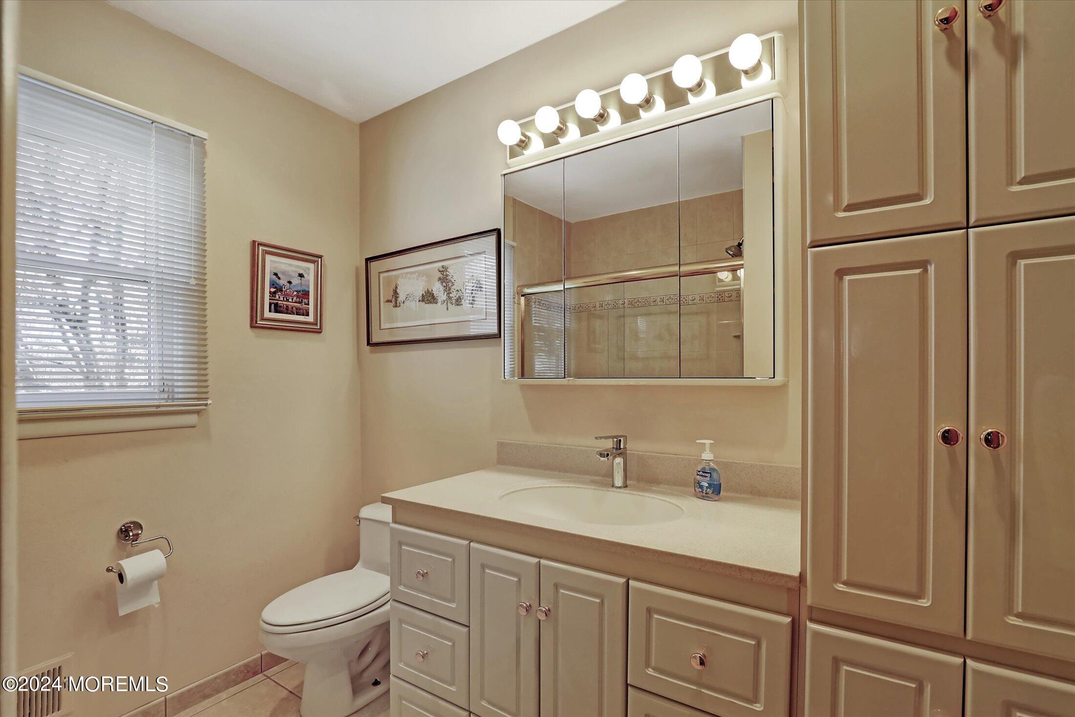 31 Shady Lane Freehold, NJ 07728 - Photo 24 of 40 a bathroom with a toilet sink double vanity and mirror