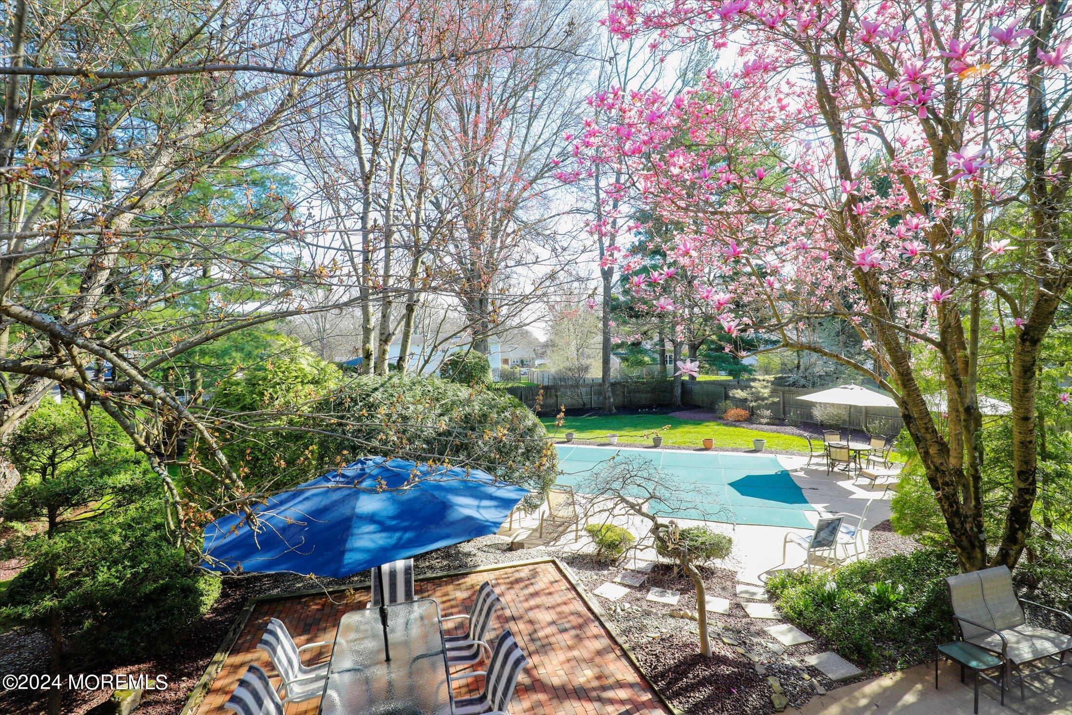 31 Shady Lane Freehold, NJ 07728 - Photo 28 of 40 a view of a backyard with table and chairs potted plants and large tree