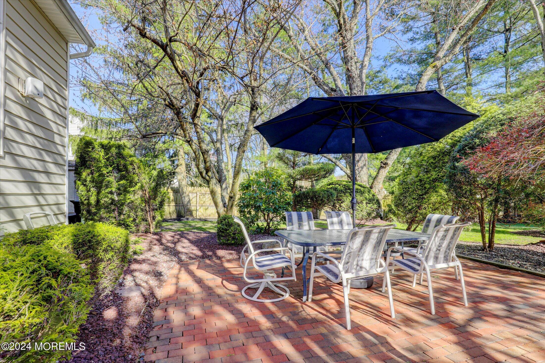 31 Shady Lane Freehold, NJ 07728 - Photo 38 of 40 a view of an outdoor space with a table and chairs under an umbrella