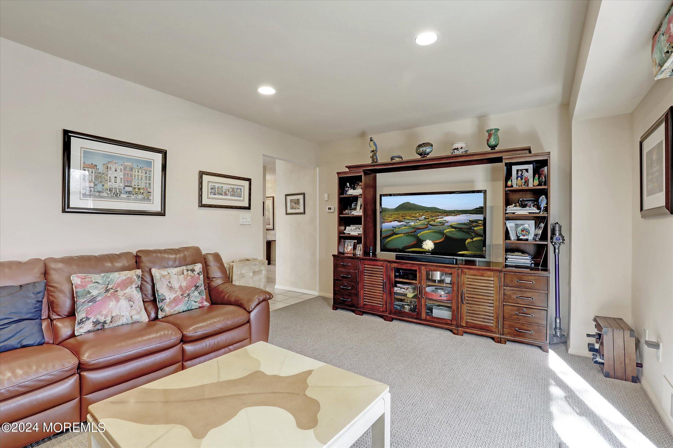 31 Shady Lane Freehold, NJ 07728 - Photo 8 of 40 a living room with furniture and a flat screen tv
