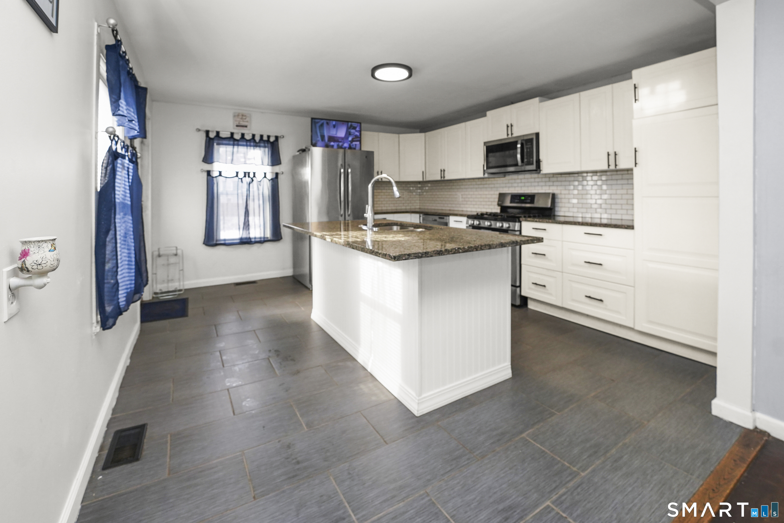 17 Windsor Street Enfield, CT 06082 - Photo 1 of 21 a kitchen with cabinets and stainless steel appliances