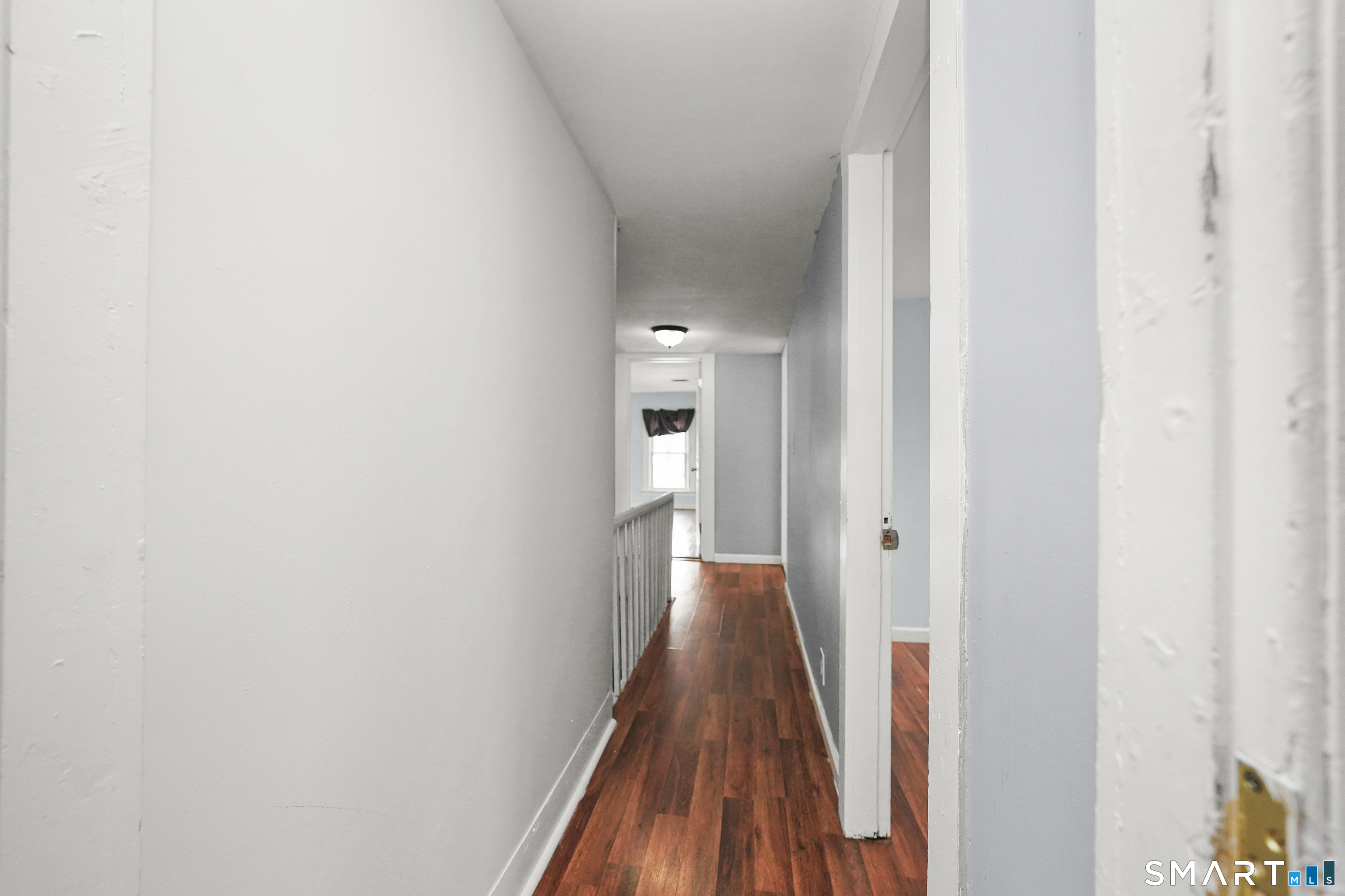 17 Windsor Street Enfield, CT 06082 - Photo 12 of 21 a view of a hallway with a wooden floor