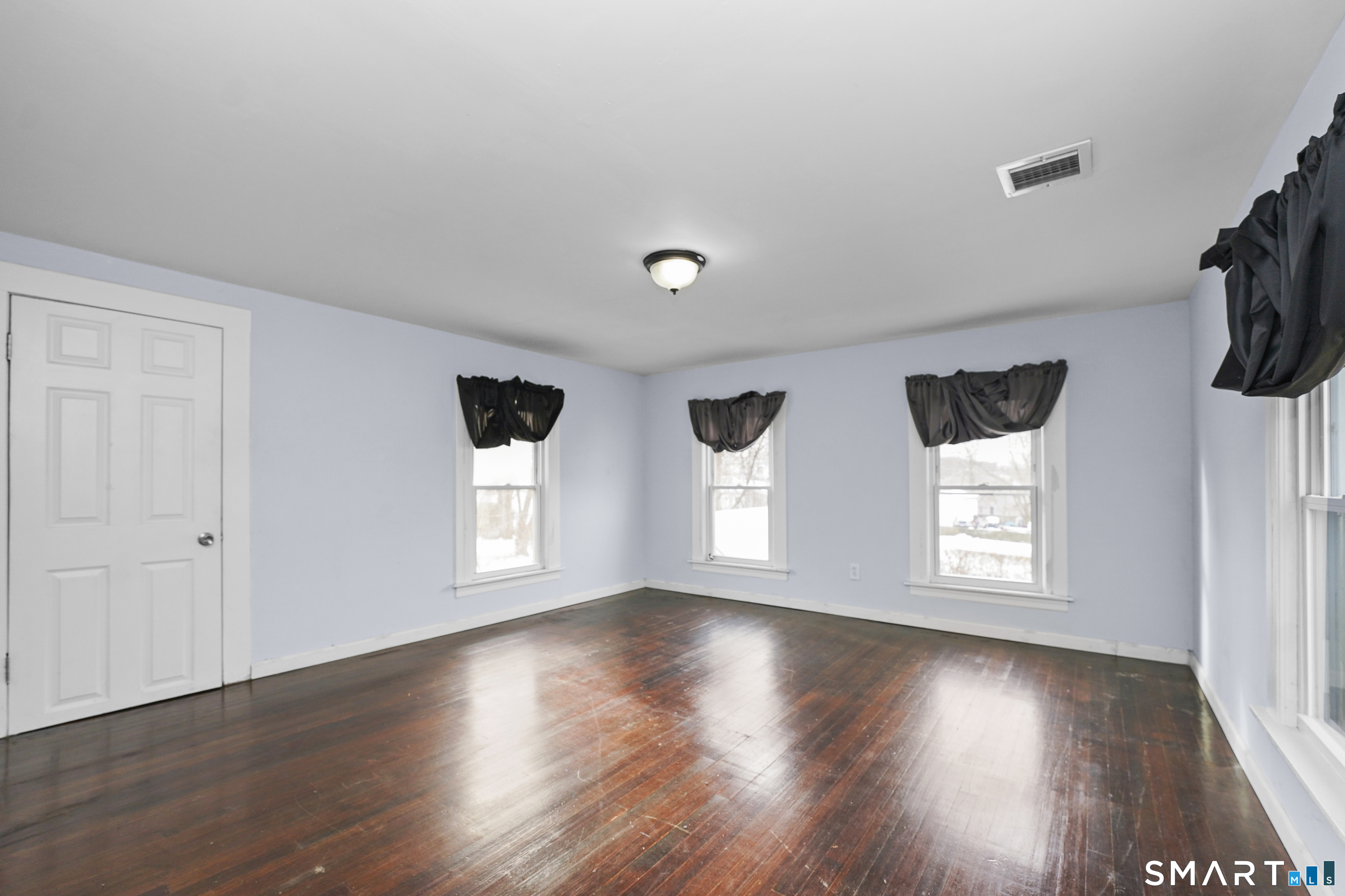 17 Windsor Street Enfield, CT 06082 - Photo 15 of 21 a view of empty room with wooden floor and fan