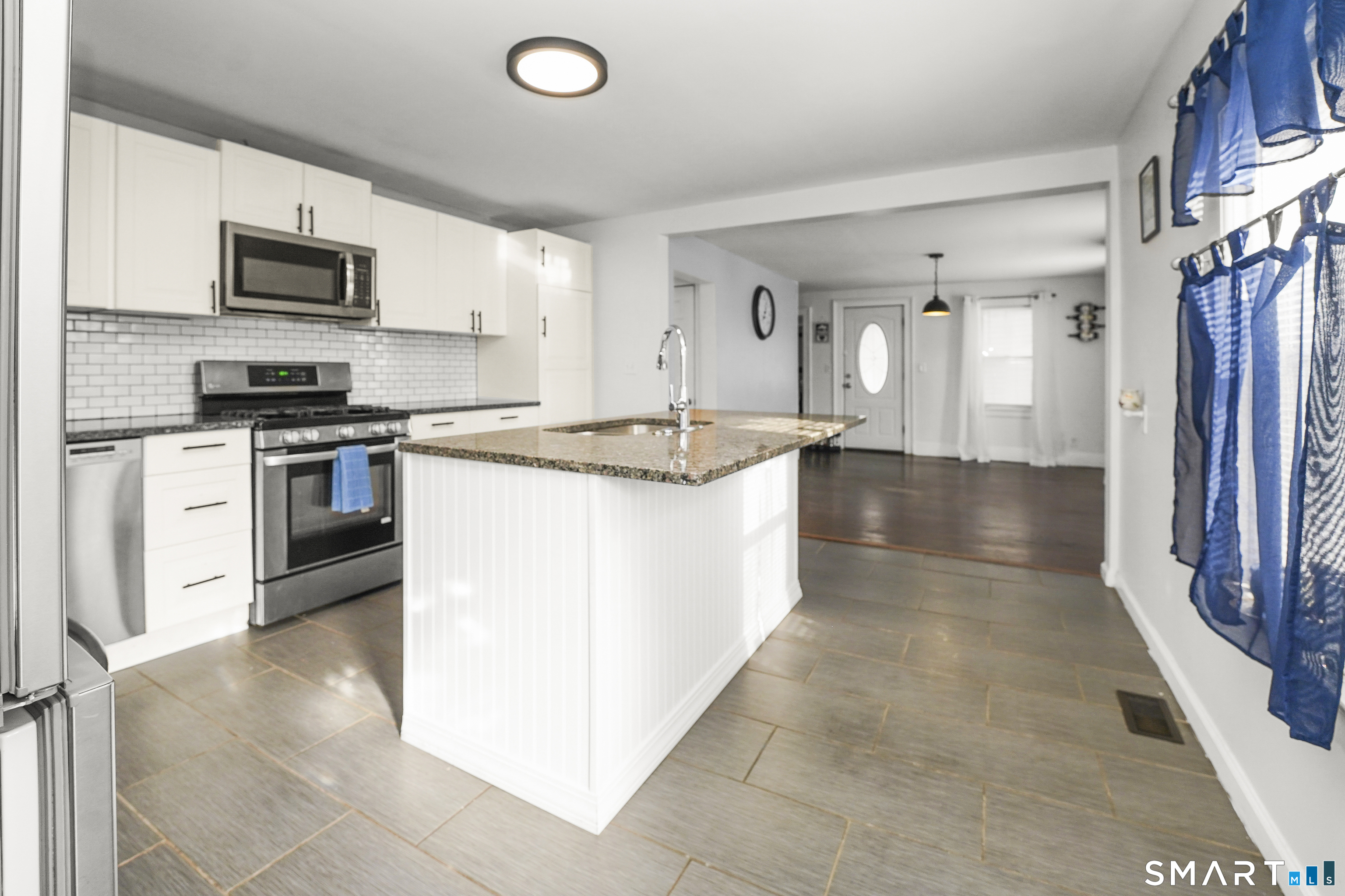 17 Windsor Street Enfield, CT 06082 - Photo 2 of 21 a kitchen with stainless steel appliances granite countertop a stove top oven a sink a counter top space and cabinets