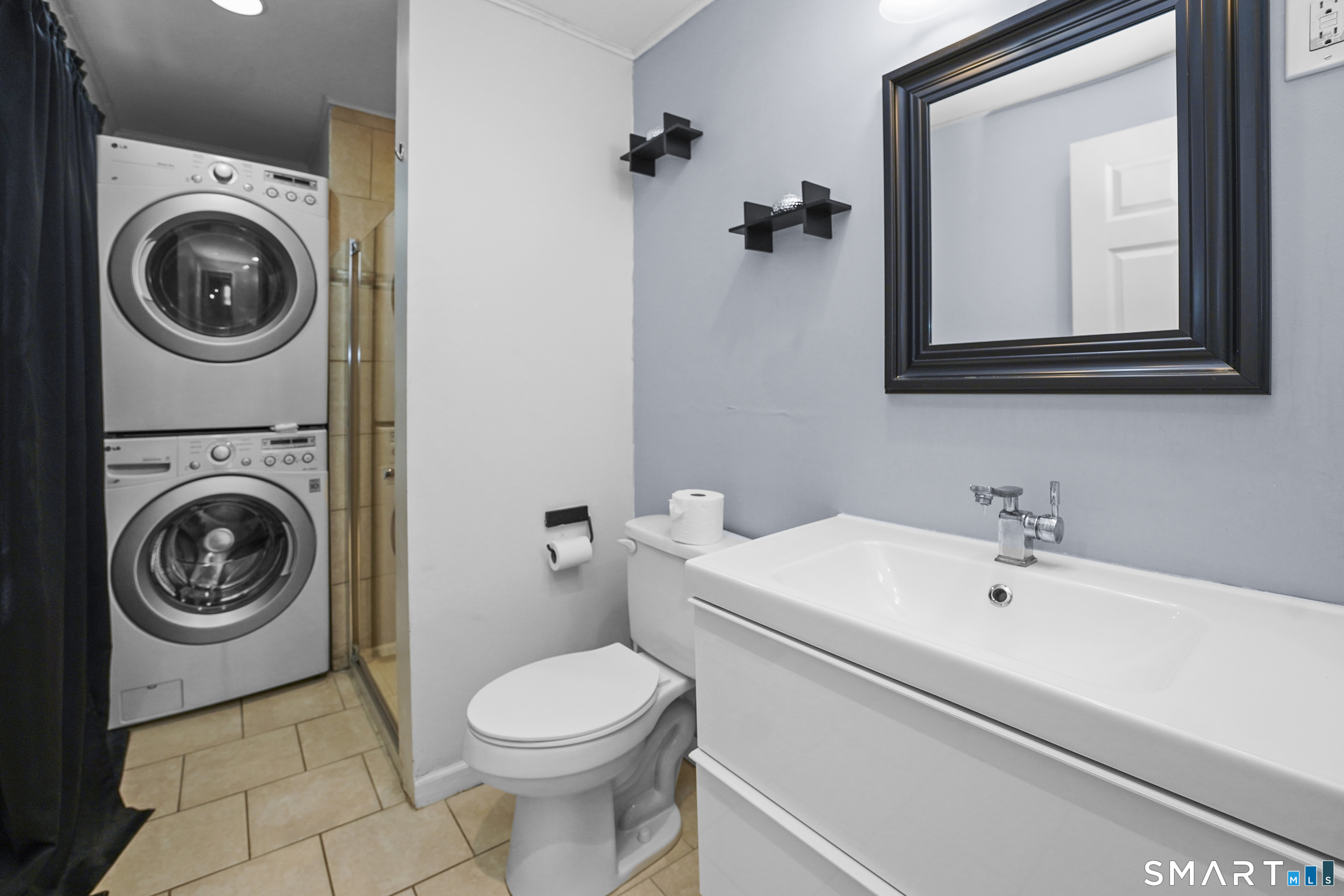17 Windsor Street Enfield, CT 06082 - Photo 9 of 21 a bathroom with a sink a toilet and mirror