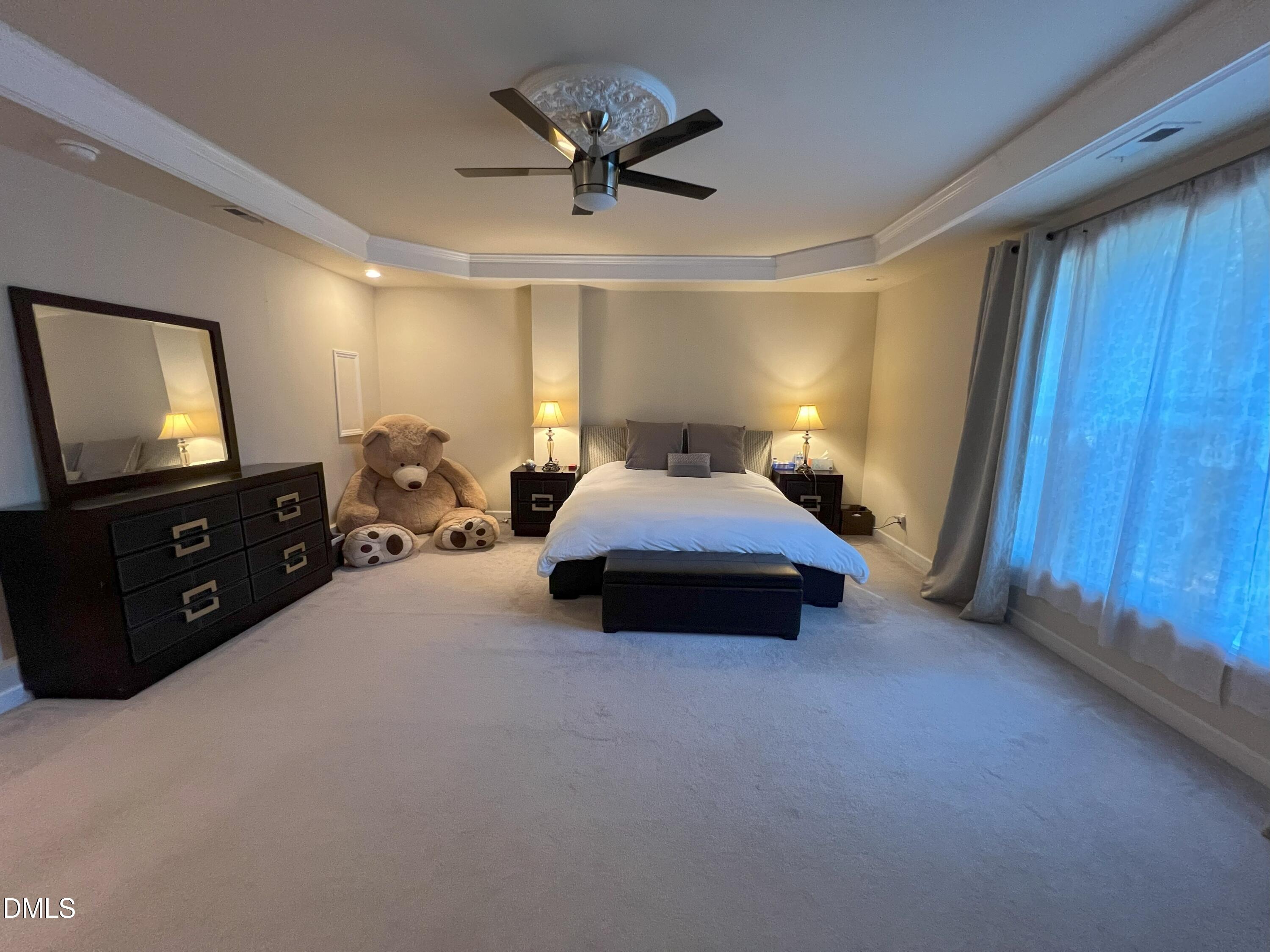 5002 Wickham Road Raleigh, NC 27606 - Photo 16 of 36 a spacious bedroom with a bed and a tv on wall