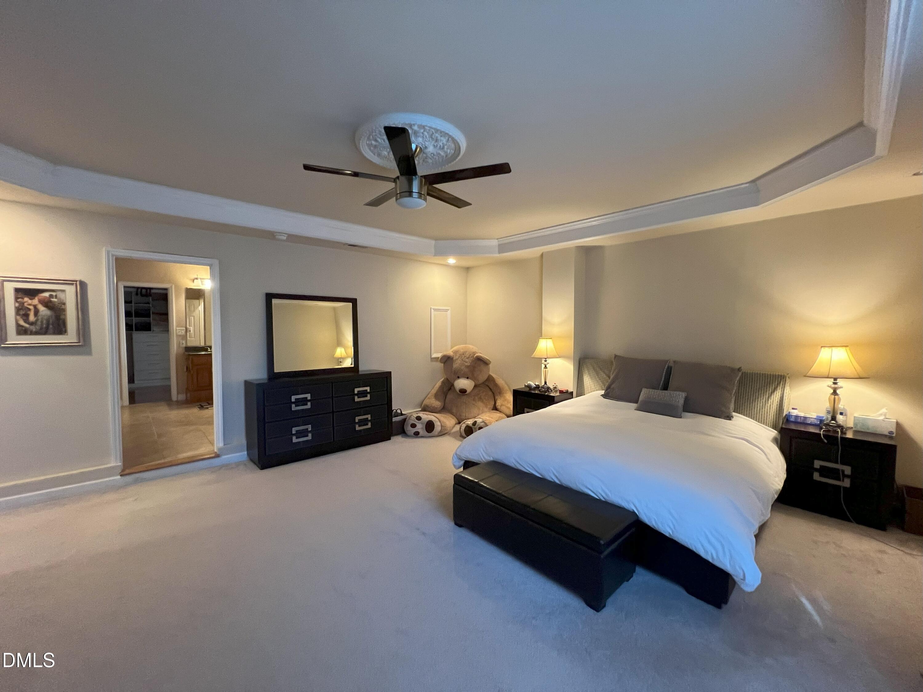 5002 Wickham Road Raleigh, NC 27606 - Photo 17 of 36 a spacious bedroom with a bed and a view of bathroom