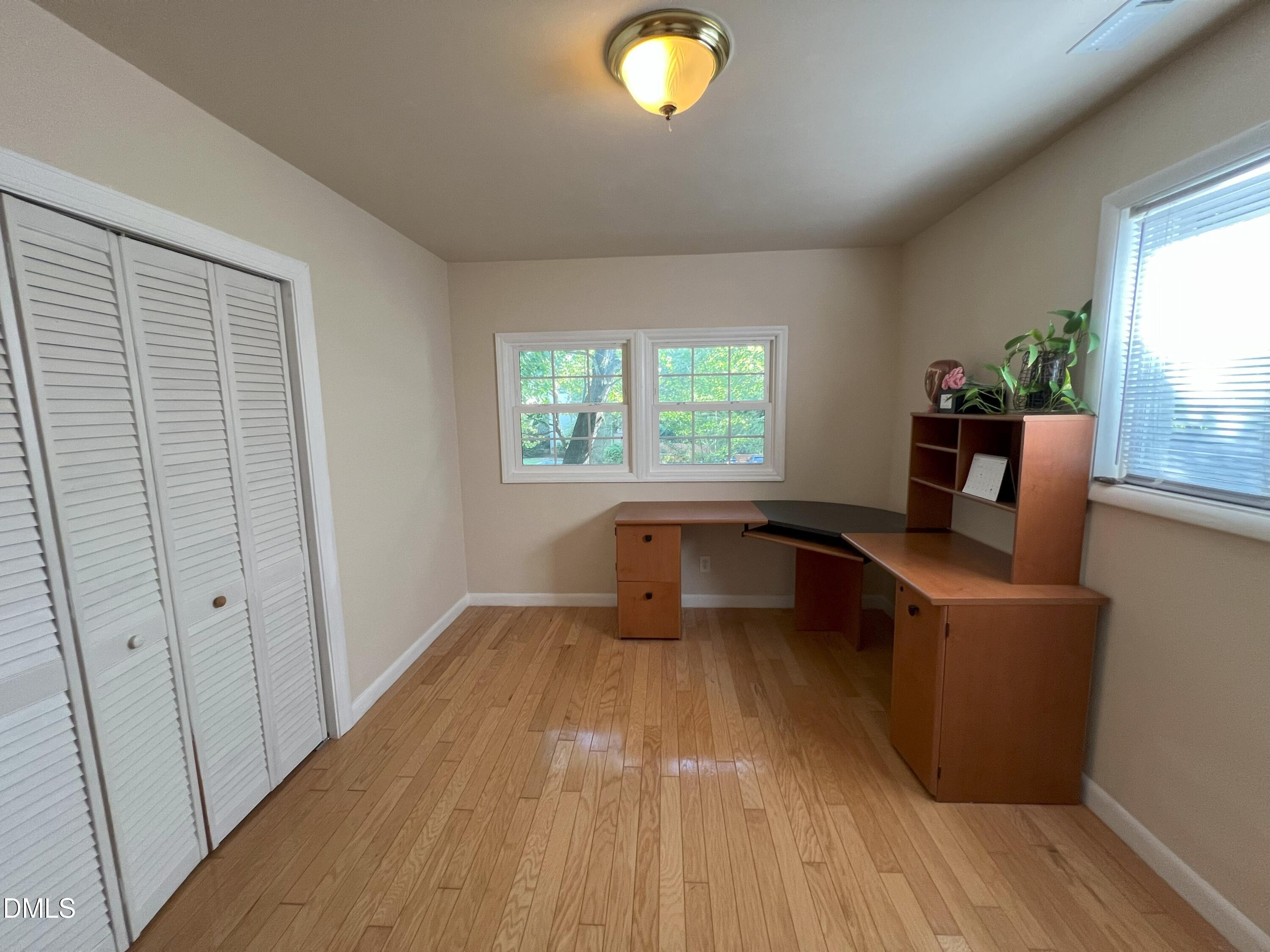 5002 Wickham Road Raleigh, NC 27606 - Photo 23 of 36 wooden floor chandelier and windows in a room