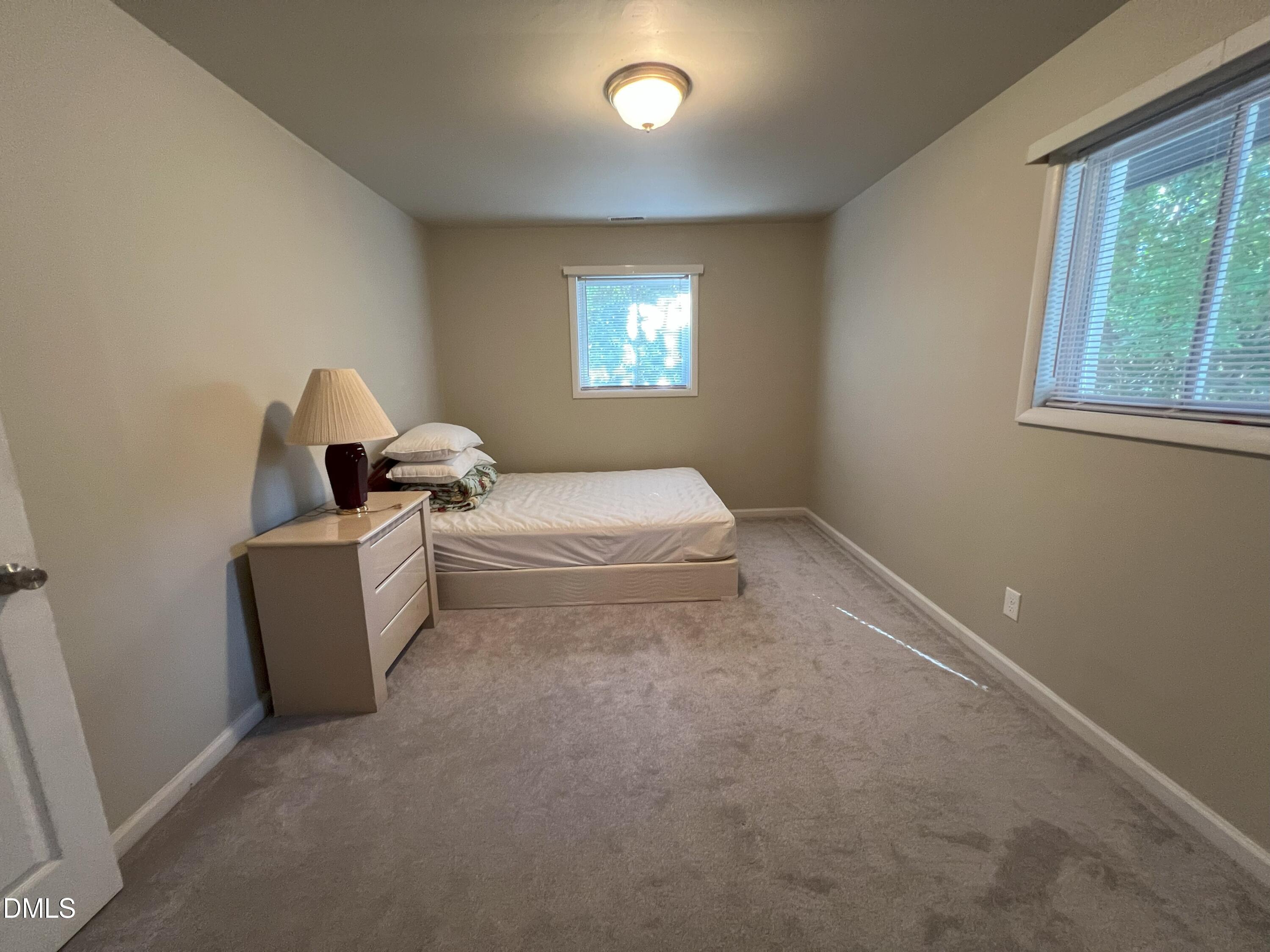 5002 Wickham Road Raleigh, NC 27606 - Photo 24 of 36 a room with bed and window