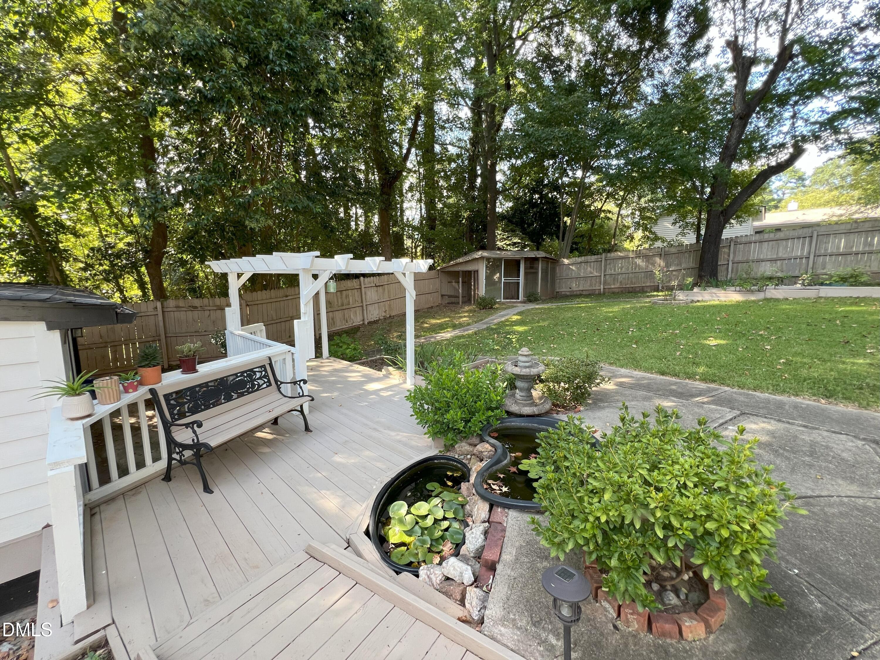 5002 Wickham Road Raleigh, NC 27606 - Photo 36 of 36 a view of a backyard with sitting area and garden