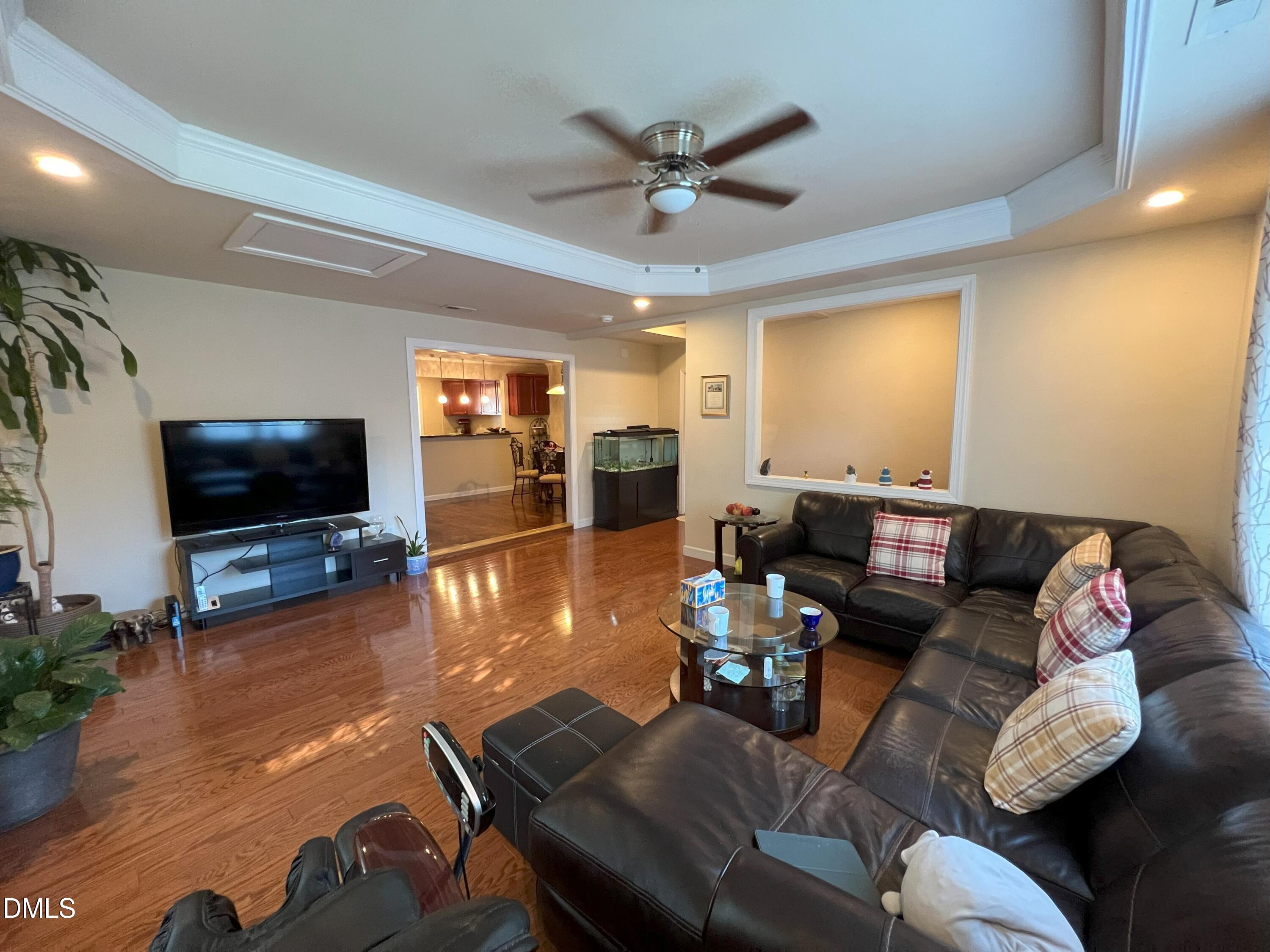5002 Wickham Road Raleigh, NC 27606 - Photo 8 of 36 a living room with furniture and a flat screen tv