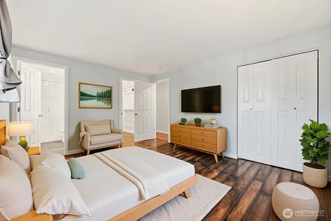 a bedroom with a bed and flat screen tv